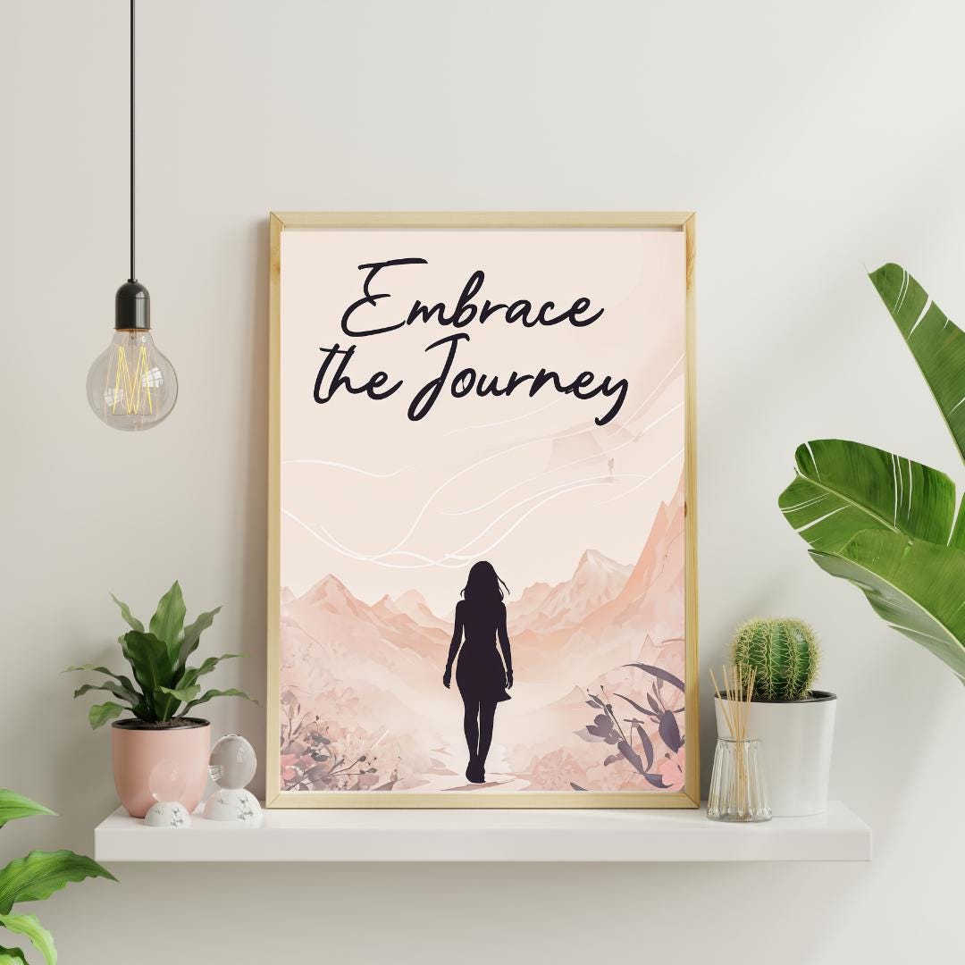 Minimalist poster with the words "Embrace the Journey" in elegant script, featuring the silhouette of a woman walking through a serene mountain landscape in soft, neutral tones. A motivational feminine design symbolizing resilience and discovery.