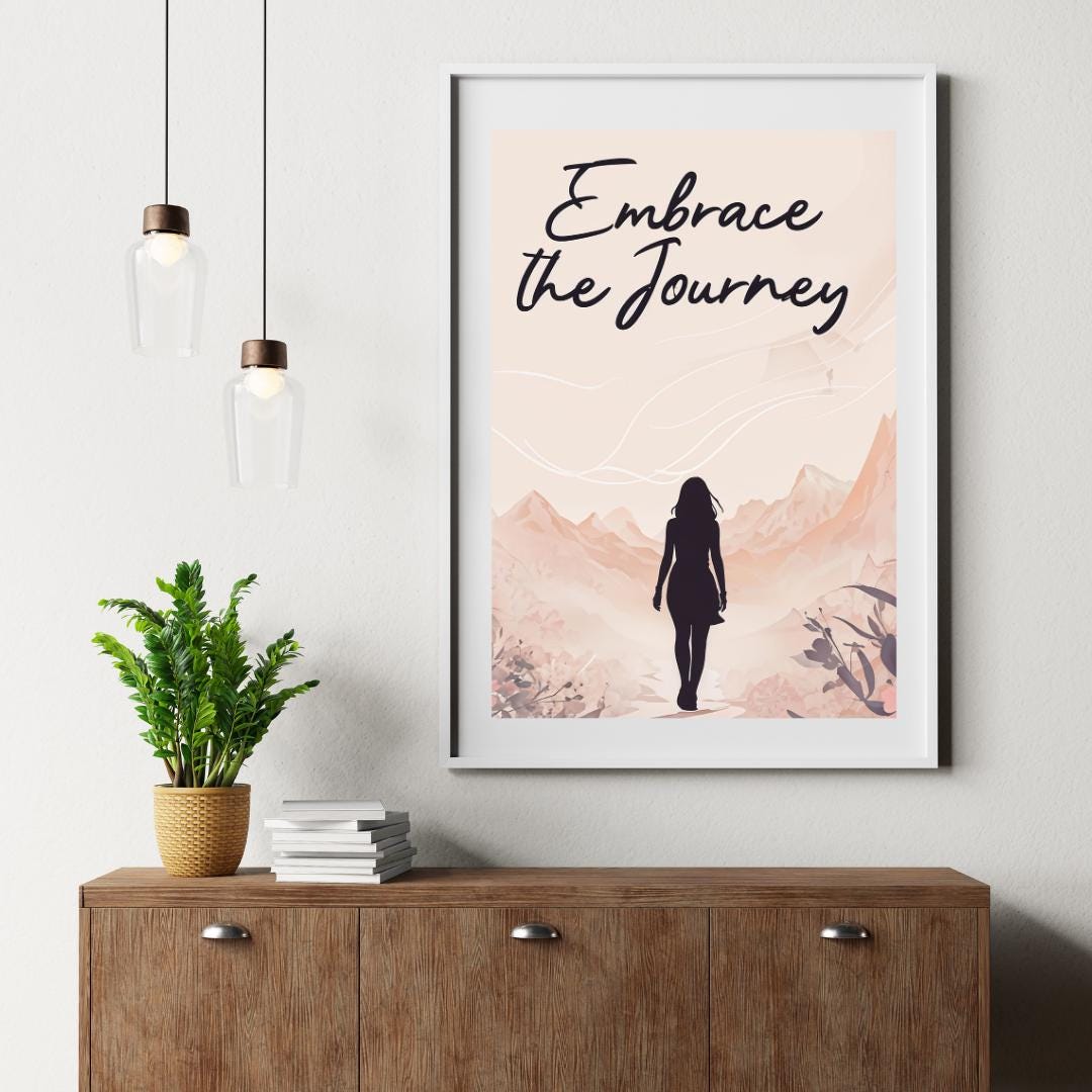 Minimalist poster with the words "Embrace the Journey" in elegant script, featuring the silhouette of a woman walking through a serene mountain landscape in soft, neutral tones. A motivational feminine design symbolizing resilience and discovery.